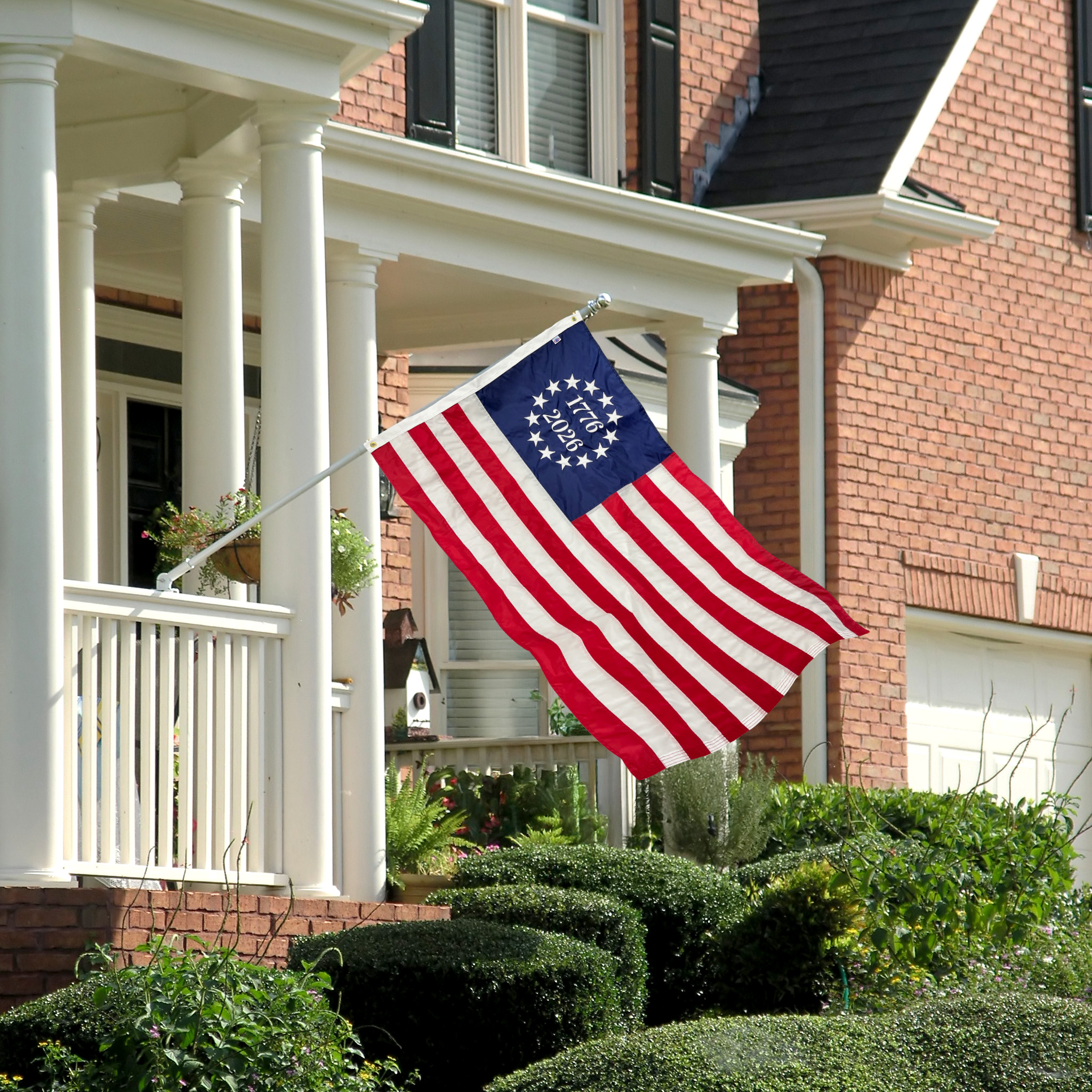 American flag waving in the wind in a neighborhood.